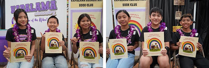 Kapālama students displaying the book